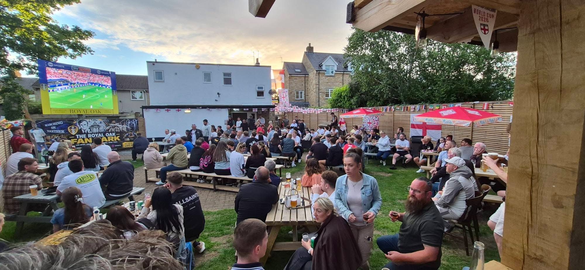 The Royal Oak beer garden full of customers watching sport on the big screen